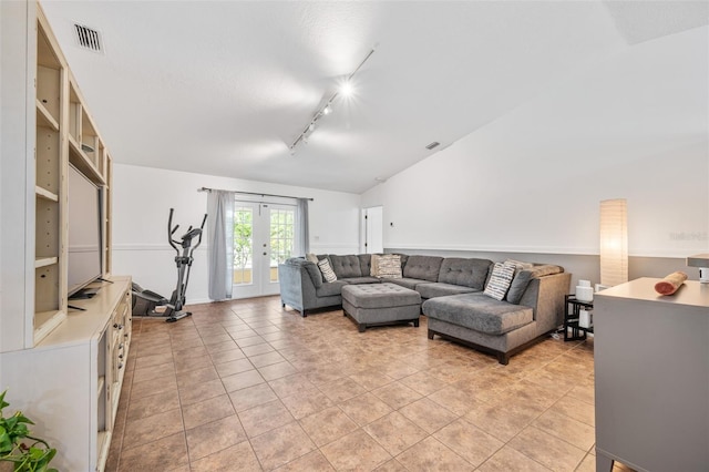 living room featuring vaulted ceiling, rail lighting, visible vents, french doors, and light tile patterned flooring