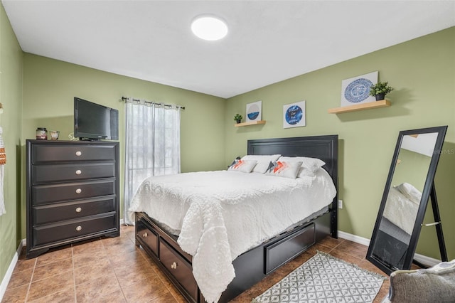 bedroom featuring baseboards and tile patterned flooring