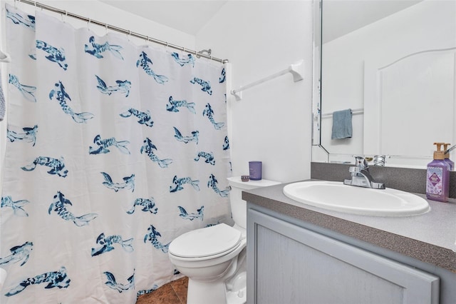 bathroom featuring curtained shower, vanity, tile patterned flooring, and toilet