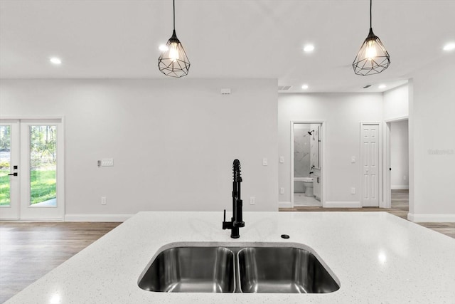 3851 W Wilburton Dr, Citrus Springs, FL 34433 - kitchen with recessed lighting, decorative light fixtures, light stone counters, and a sink