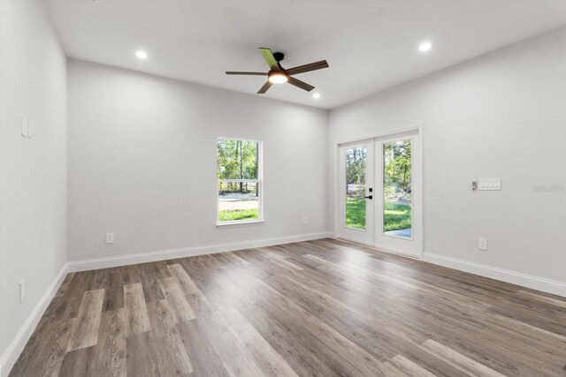 3851 W Wilburton Dr, Citrus Springs, FL 34433 - spare room featuring recessed lighting, wood finished floors, ceiling fan, and plenty of natural light