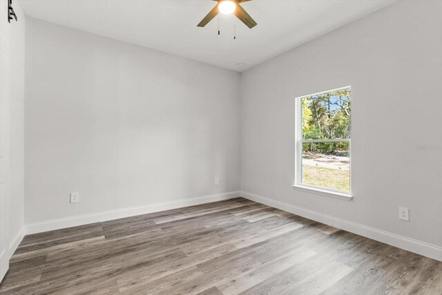 3851 W Wilburton Dr, Citrus Springs, FL 34433 - spare room with wood finished floors, ceiling fan, and baseboards