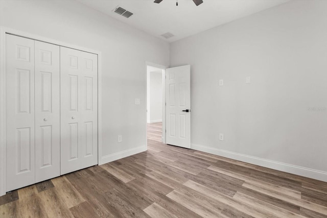 3851 W Wilburton Dr, Citrus Springs, FL 34433 - unfurnished bedroom with wood finished floors, a closet, baseboards, visible vents, and a ceiling fan