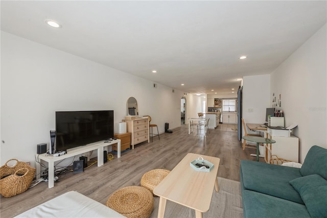 living area with recessed lighting and wood finished floors