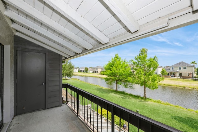 balcony featuring a residential view and a water view