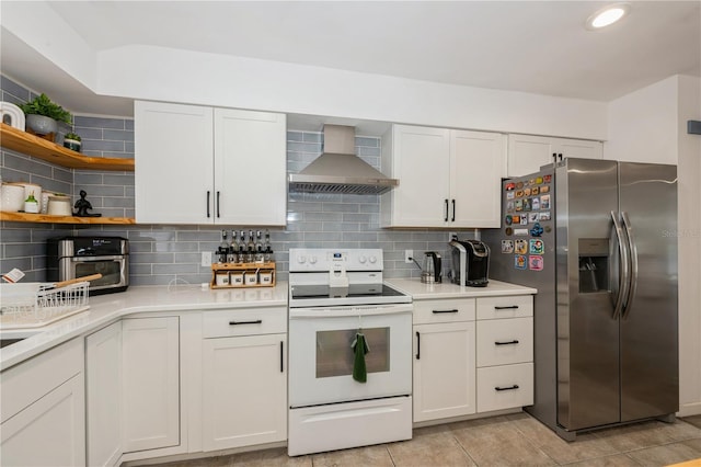 kitchen featuring open shelves, stainless steel refrigerator with ice dispenser, light countertops, white electric range oven, and wall chimney exhaust hood