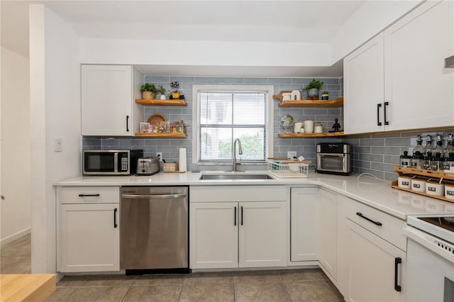 kitchen featuring open shelves, appliances with stainless steel finishes, decorative backsplash, and a sink