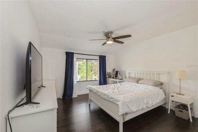 bedroom with dark wood finished floors, baseboards, ceiling fan, and vaulted ceiling