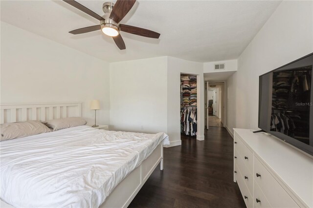 bedroom with visible vents, ceiling fan, dark wood-style floors, and baseboards