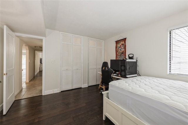 bedroom with baseboards and dark wood finished floors