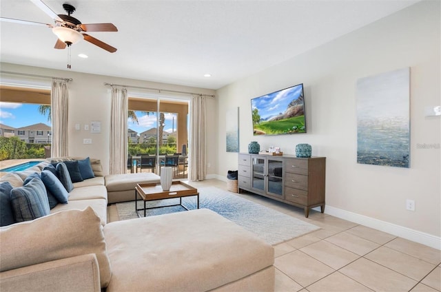 living room featuring light tile patterned floors, baseboards, a ceiling fan, and recessed lighting