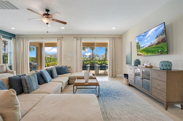 living area featuring light tile patterned floors, ceiling fan, recessed lighting, and visible vents