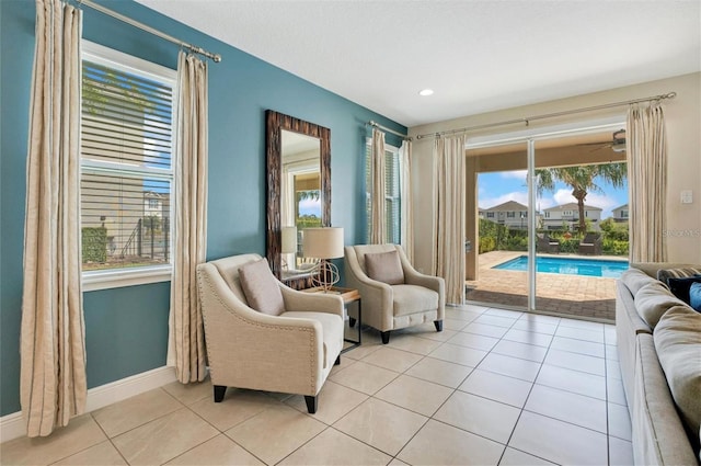 sitting room featuring light tile patterned flooring, baseboards, and recessed lighting