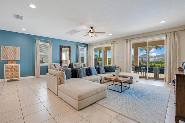 living room with light tile patterned floors, ceiling fan, recessed lighting, and visible vents