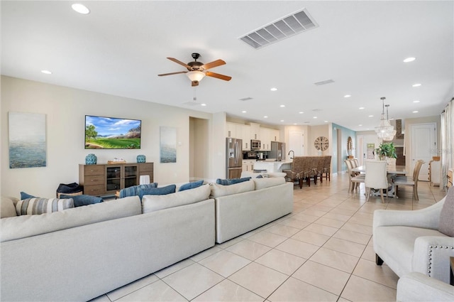 living room with light tile patterned floors, a ceiling fan, recessed lighting, and visible vents