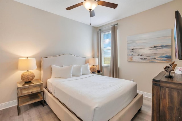 bedroom featuring baseboards, a ceiling fan, and wood finished floors