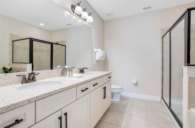 bathroom featuring a sink, a stall shower, and visible vents