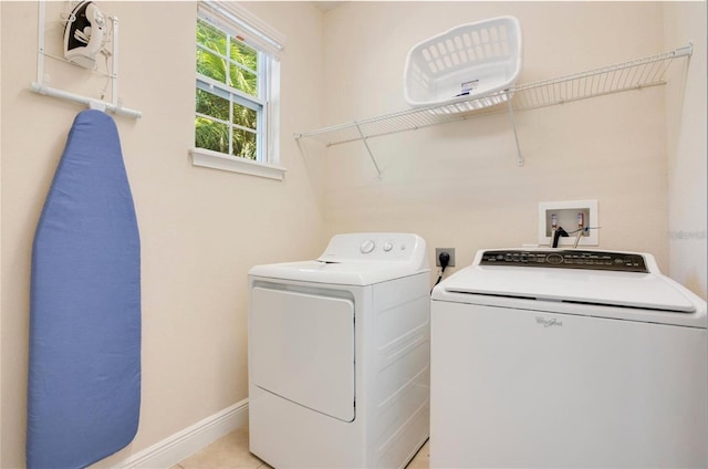 washroom featuring baseboards, laundry area, and washer and clothes dryer