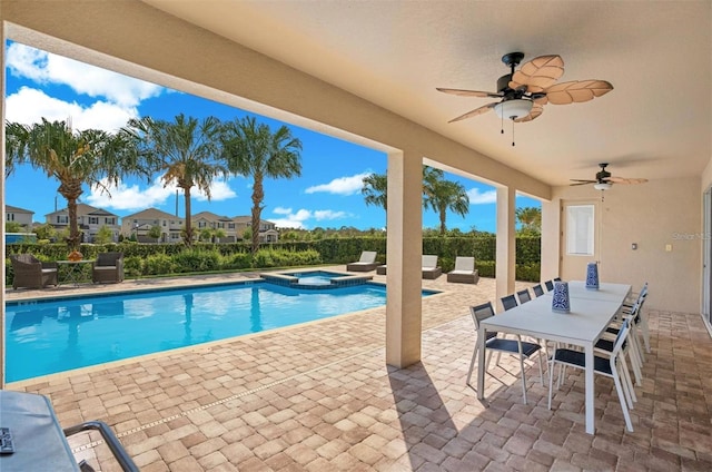 view of swimming pool featuring a patio, ceiling fan, and a pool with connected hot tub