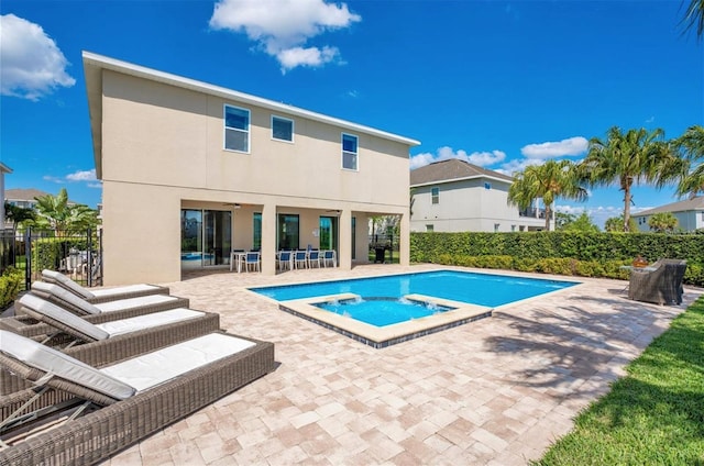 view of pool with an in ground hot tub, a fenced in pool, and a patio area