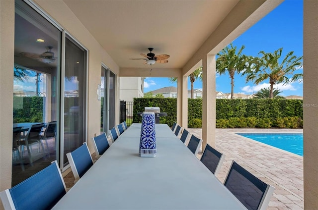 view of patio featuring a fenced in pool, a ceiling fan, outdoor dining area, and fence