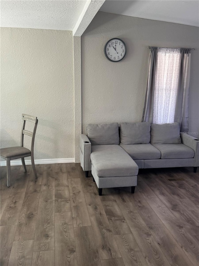9400 SE 119th St, Belleview, FL 34420 - living area with a textured wall, baseboards, and dark wood-style flooring