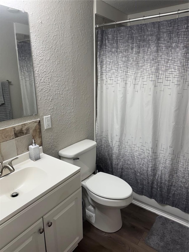 9400 SE 119th St, Belleview, FL 34420 - bathroom featuring a textured wall, wood finished floors, vanity, and toilet