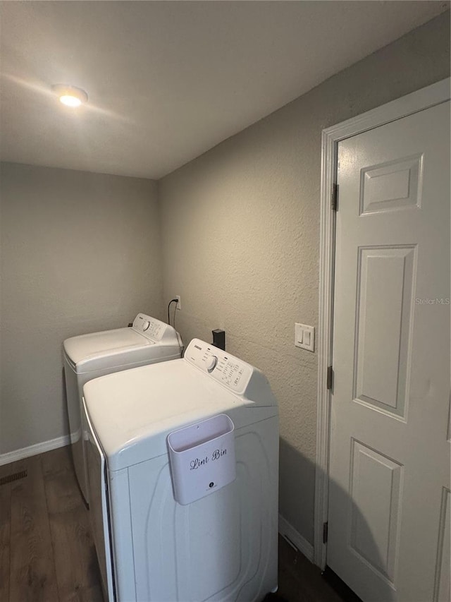 9400 SE 119th St, Belleview, FL 34420 - clothes washing area featuring baseboards, washer and clothes dryer, laundry area, and dark wood-style flooring