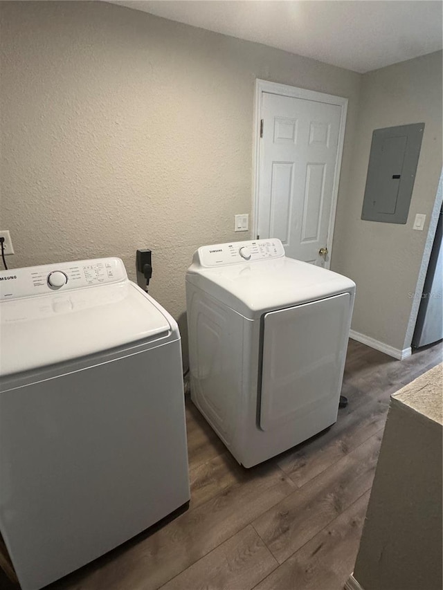 9400 SE 119th St, Belleview, FL 34420 - washroom featuring separate washer and dryer, electric panel, baseboards, and dark wood-style floors