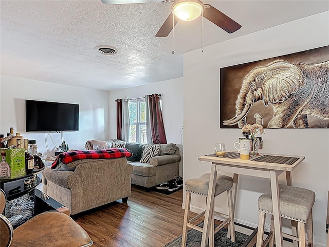 741 Hillview Dr, Altamonte Springs, FL 32714 - living room with a textured ceiling, visible vents, ceiling fan, and wood finished floors