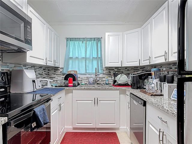 741 Hillview Dr, Altamonte Springs, FL 32714 - kitchen with tasteful backsplash, stainless steel appliances, white cabinets, a sink, and crown molding