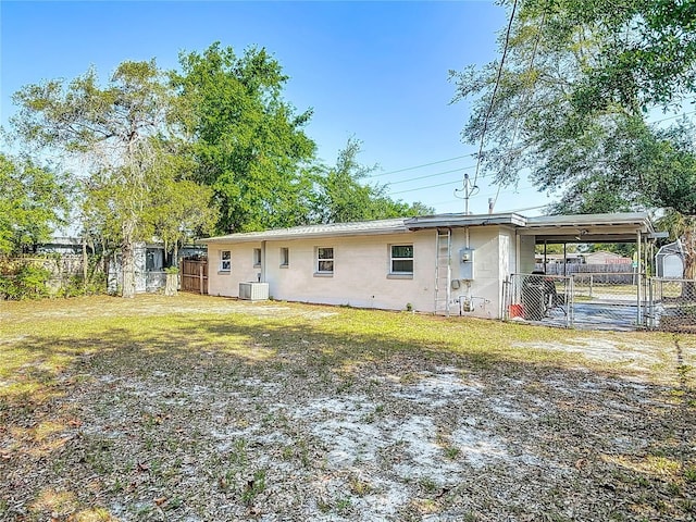 741 Hillview Dr, Altamonte Springs, FL 32714 - back of property with central air condition unit, fence, an attached carport, and a gate
