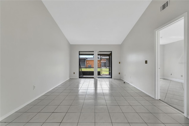 spare room with high vaulted ceiling, baseboards, light tile patterned flooring, and visible vents
