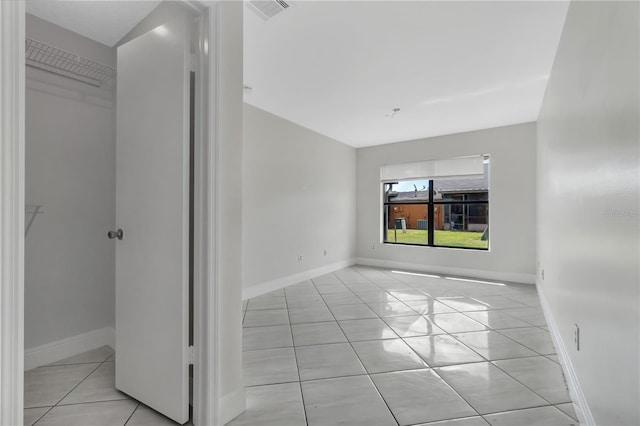 unfurnished room featuring visible vents, baseboards, and light tile patterned floors