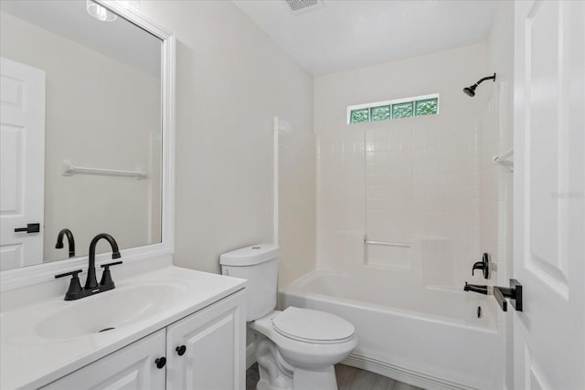 bathroom with toilet, visible vents, vanity, and  shower combination