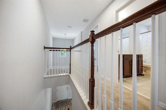 stairs featuring visible vents and carpet