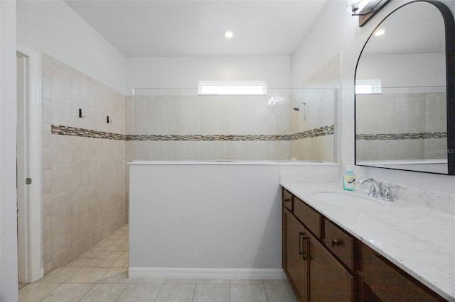 bathroom with walk in shower, tile patterned floors, and vanity