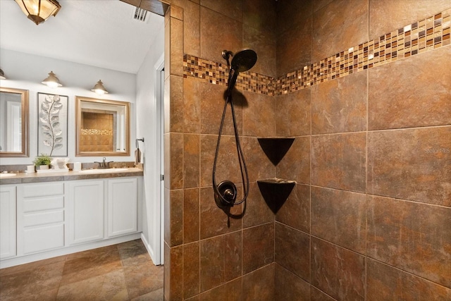 955 Seminole St, Clermont, FL 34711 - bathroom featuring double vanity, a tile shower, and a sink