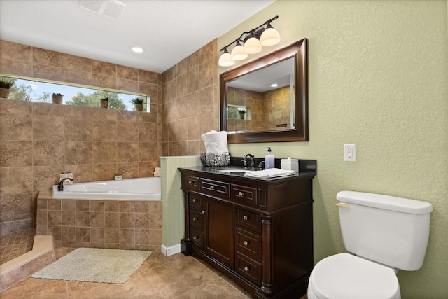 955 Seminole St, Clermont, FL 34711 - full bathroom with a textured wall, vanity, toilet, tile patterned floors, and a garden tub