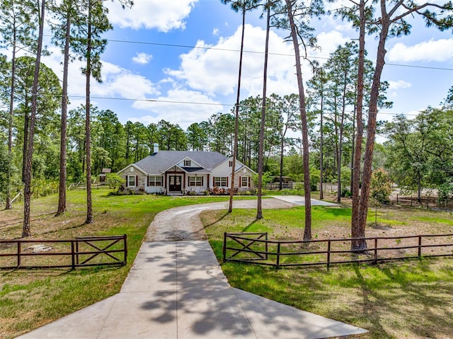 42368 W Cashew Ct, Eustis, FL 32736 - view of front facade with a front yard, a chimney, curved driveway, and fence