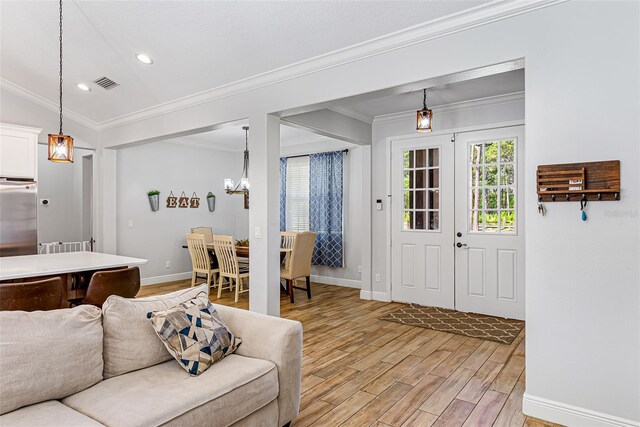 42368 W Cashew Ct, Eustis, FL 32736 - living area featuring light wood finished floors, an inviting chandelier, visible vents, and baseboards