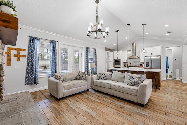 42368 W Cashew Ct, Eustis, FL 32736 - living area featuring an inviting chandelier, crown molding, light wood finished floors, and baseboards