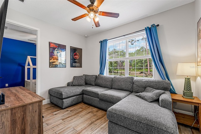 42368 W Cashew Ct, Eustis, FL 32736 - living area with light wood-style floors, ceiling fan, and baseboards