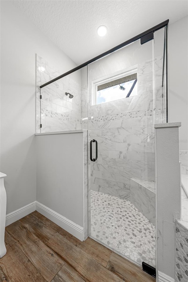 42368 W Cashew Ct, Eustis, FL 32736 - full bath featuring wood finished floors, a textured ceiling, and a stall shower
