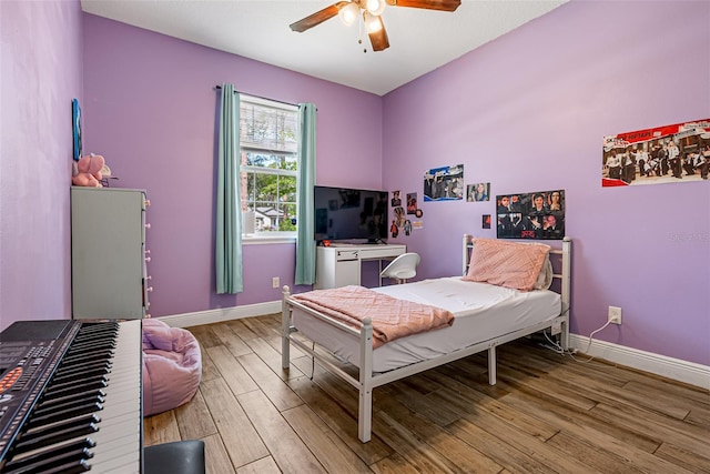 42368 W Cashew Ct, Eustis, FL 32736 - bedroom featuring baseboards, a ceiling fan, and light wood finished floors
