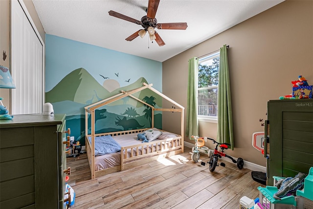 42368 W Cashew Ct, Eustis, FL 32736 - bedroom with baseboards, wood finished floors, and a ceiling fan