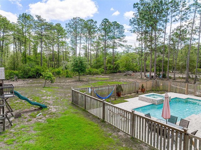 42368 W Cashew Ct, Eustis, FL 32736 - view of pool with an in ground hot tub, a playground, a fenced in pool, fence, and a yard
