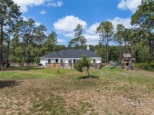 42368 W Cashew Ct, Eustis, FL 32736 - view of yard with a deck, a playground, and fence