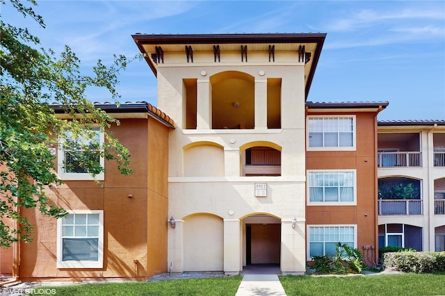 view of front facade featuring stucco siding and a tiled roof
