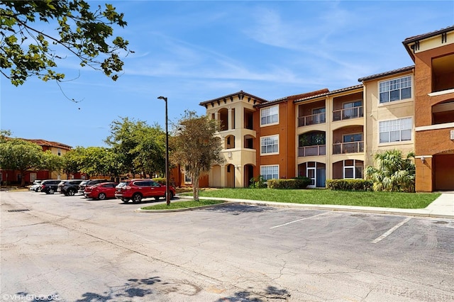 view of property with uncovered parking
